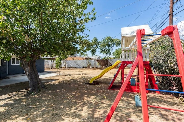 view of jungle gym featuring fence