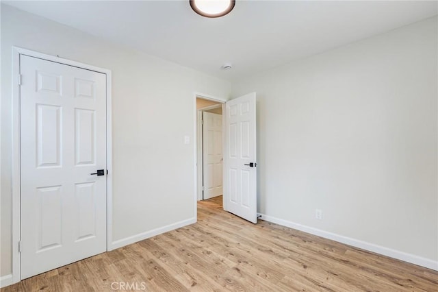 unfurnished bedroom with light wood-type flooring