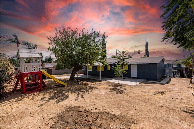 exterior space with a playground and a patio area