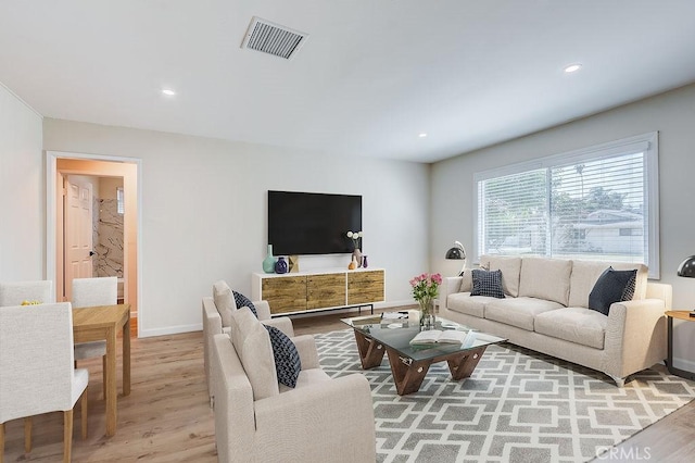 living room featuring light wood-style flooring, recessed lighting, baseboards, and visible vents