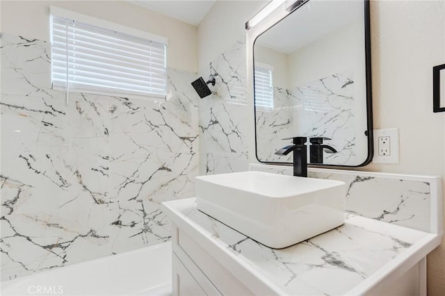 bathroom with vanity and tiled shower / bath combo