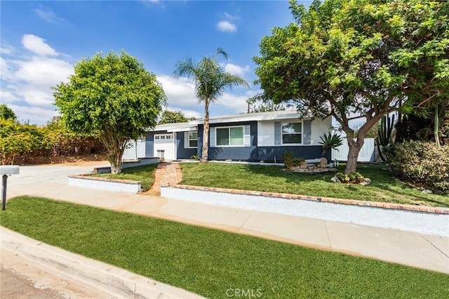 ranch-style house with a garage, driveway, a front yard, and stucco siding