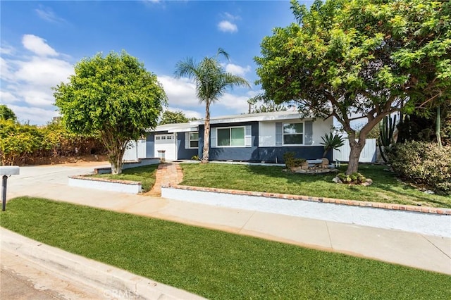 single story home featuring a front yard, an attached garage, driveway, and stucco siding