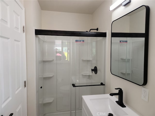 full bathroom featuring a shower stall and a sink