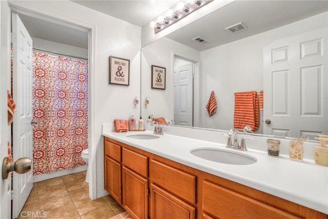 bathroom with toilet, vanity, and a shower with shower curtain