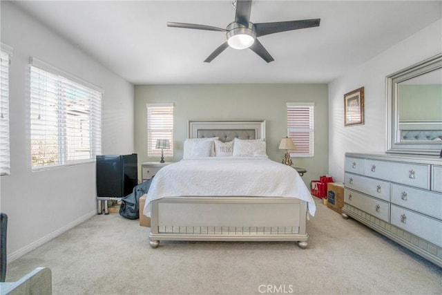 bedroom featuring ceiling fan and light carpet