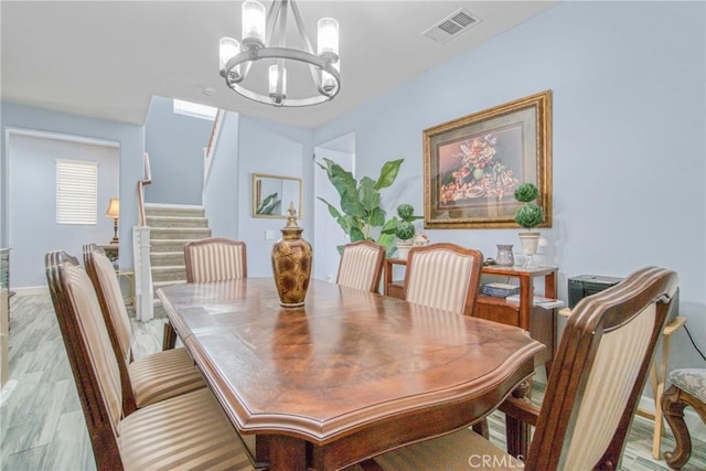 dining room featuring a chandelier and light hardwood / wood-style floors