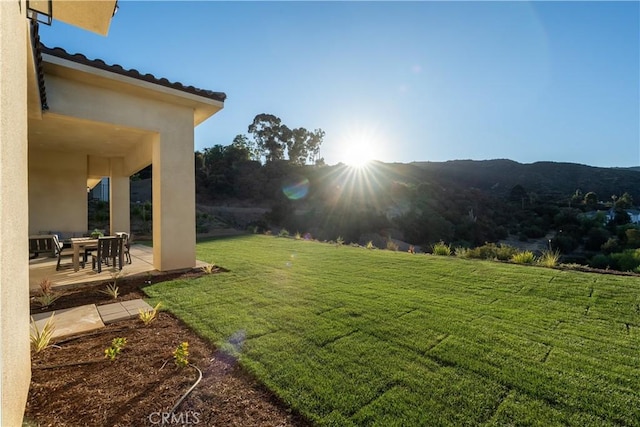 view of yard with a mountain view and a patio