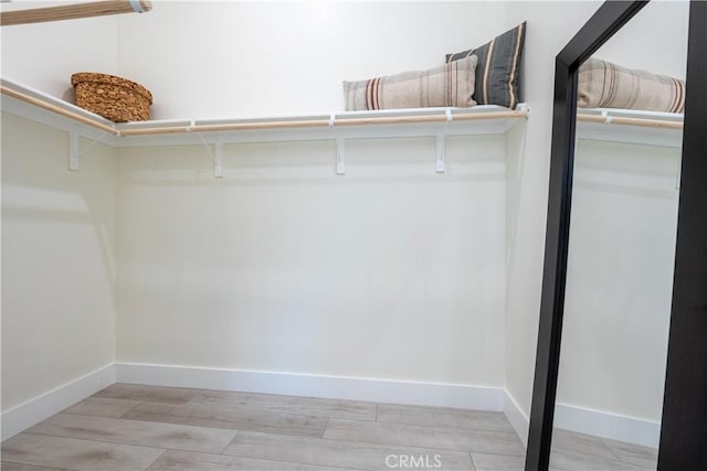 walk in closet featuring light hardwood / wood-style floors