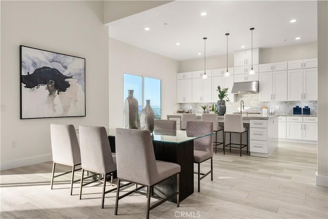 dining space featuring light hardwood / wood-style floors and sink