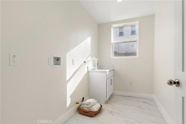 laundry area with washer hookup, cabinets, and sink