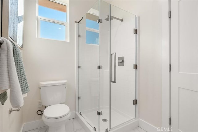 bathroom with an enclosed shower and toilet