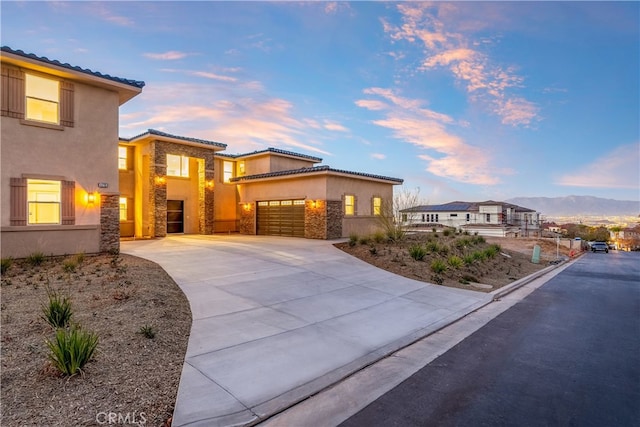 view of front of house featuring a garage and a mountain view