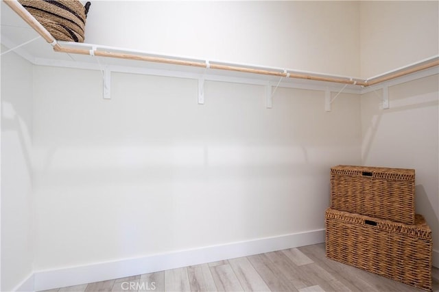 spacious closet featuring light hardwood / wood-style floors