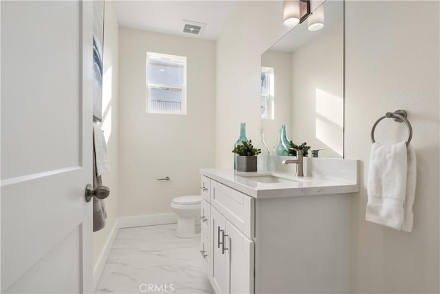 bathroom with toilet and vanity