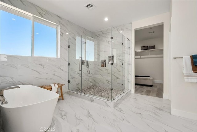 bathroom with separate shower and tub