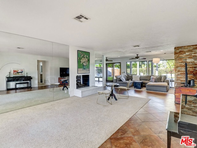 living room with ceiling fan and light tile patterned flooring