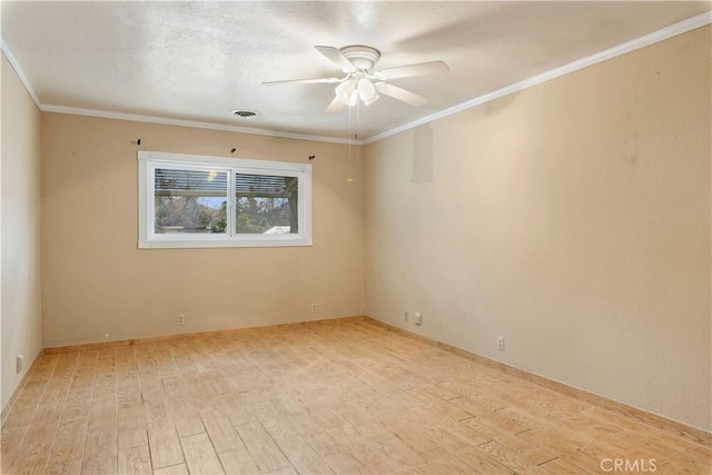 spare room featuring ceiling fan, ornamental molding, and light hardwood / wood-style floors