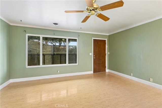 empty room with ceiling fan, crown molding, and hardwood / wood-style flooring