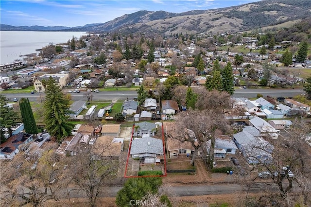 birds eye view of property featuring a water and mountain view