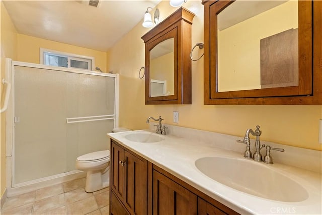 bathroom with a shower with shower door, tile patterned floors, toilet, and vanity