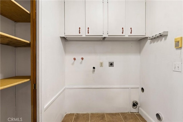 laundry room featuring washer hookup, cabinets, light tile patterned floors, and electric dryer hookup