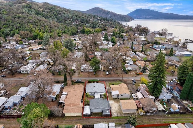 drone / aerial view featuring a water and mountain view