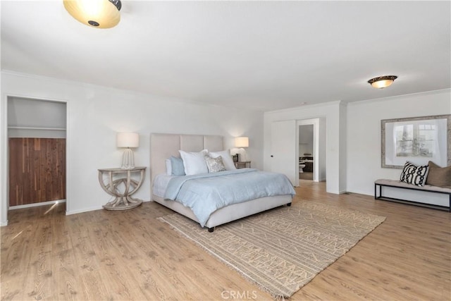 bedroom featuring ornamental molding and hardwood / wood-style floors