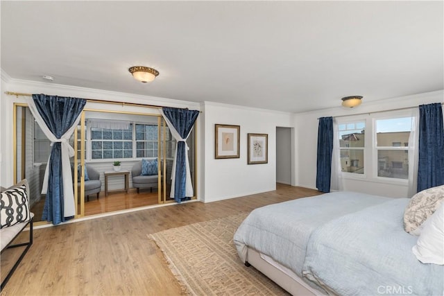 bedroom with ornamental molding and hardwood / wood-style flooring