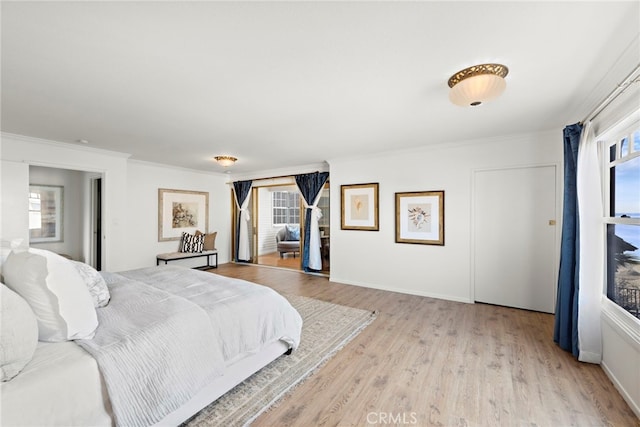 bedroom with crown molding and light hardwood / wood-style flooring