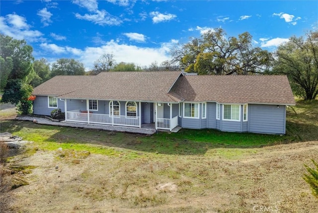 ranch-style home with a porch and a front lawn