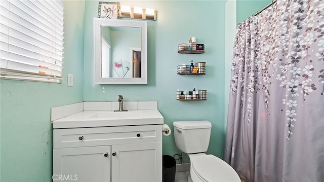 bathroom with toilet and vanity