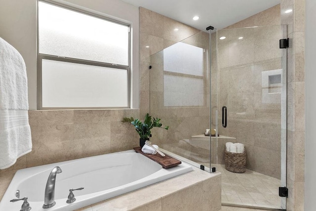 bathroom featuring lofted ceiling and separate shower and tub