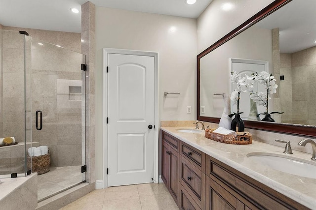 bathroom featuring a shower with door, tile patterned floors, and vanity