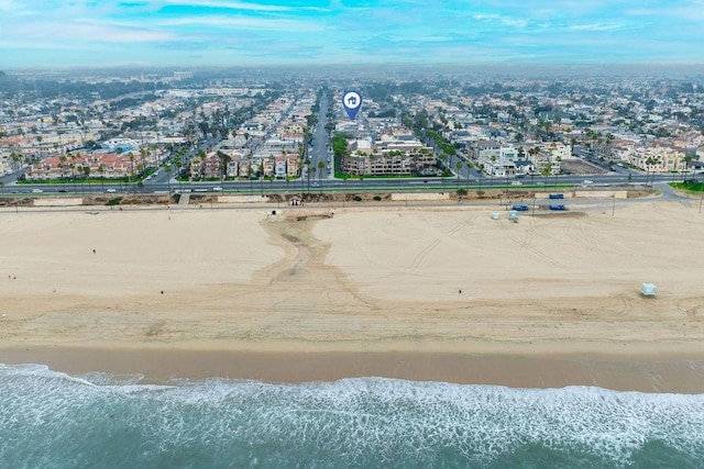 aerial view with a water view and a beach view