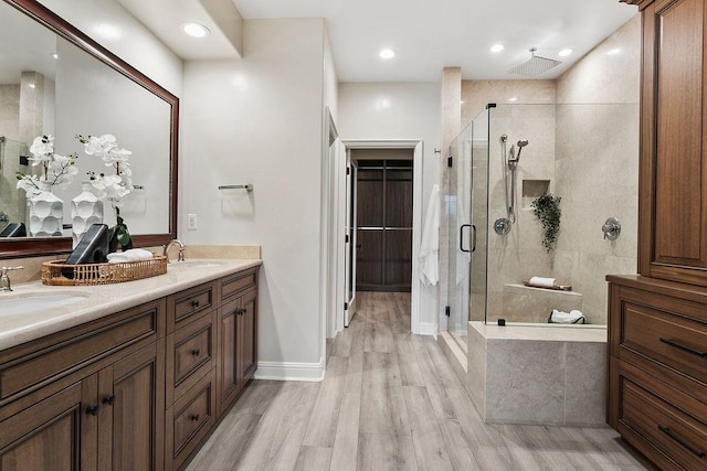 bathroom featuring vanity, hardwood / wood-style floors, and an enclosed shower