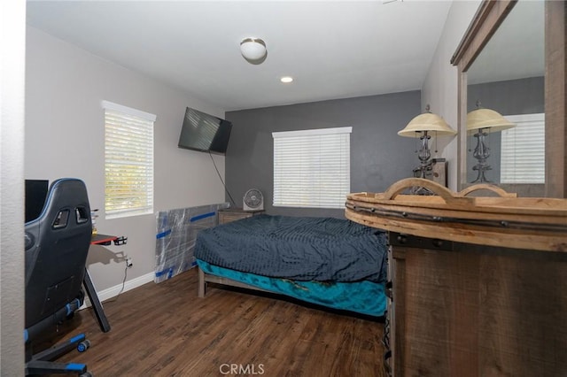 bedroom with dark wood-type flooring