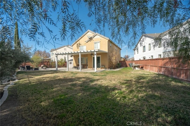 rear view of house with a yard, a patio area, and a pergola