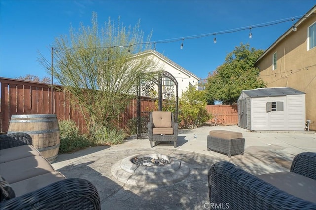 view of patio featuring an outdoor living space with a fire pit and a storage unit