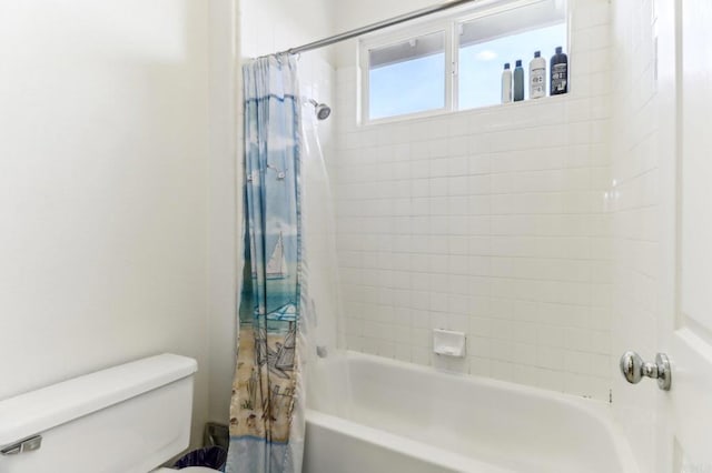 bathroom featuring toilet and shower / bath combo