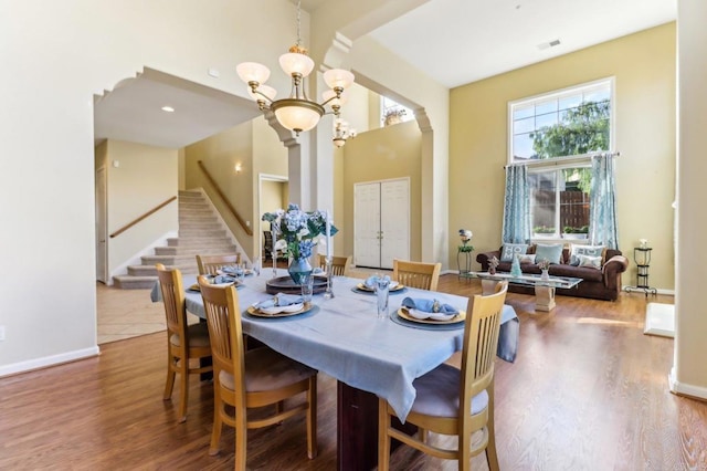 dining area with an inviting chandelier and hardwood / wood-style flooring