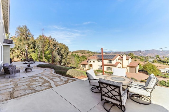 view of patio / terrace featuring a mountain view and a fire pit