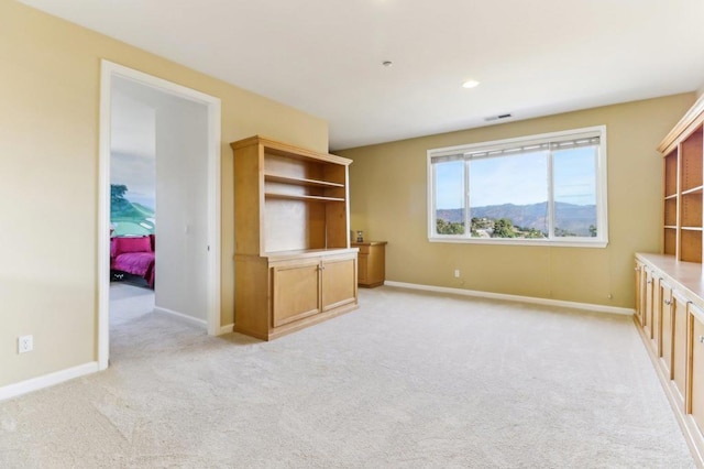 interior space featuring light carpet and a mountain view