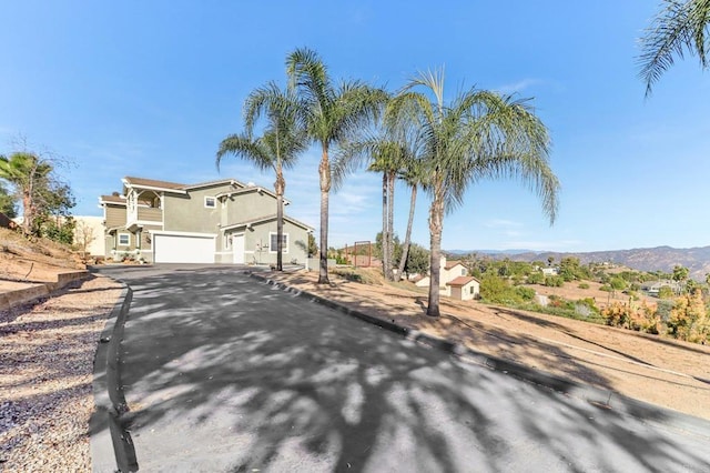 view of front of home featuring a garage and a mountain view