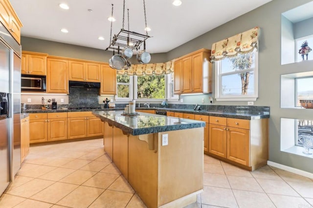 kitchen with exhaust hood, light tile patterned floors, a center island, a breakfast bar, and black appliances