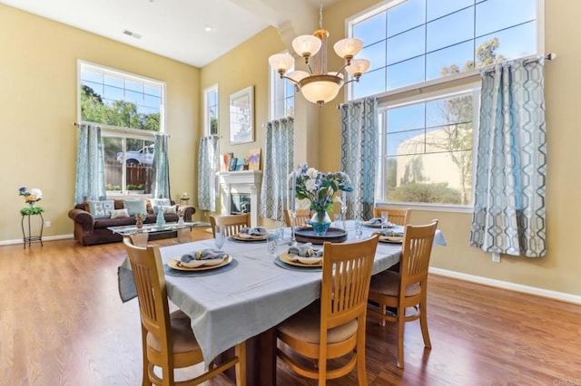 dining space featuring a notable chandelier and hardwood / wood-style flooring