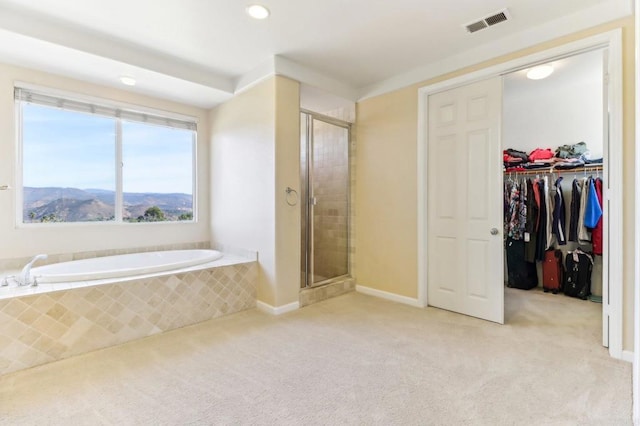 bathroom featuring independent shower and bath and a mountain view