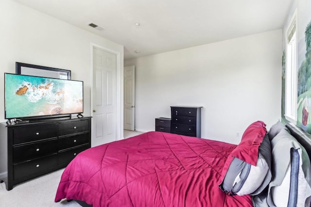 bedroom featuring light colored carpet