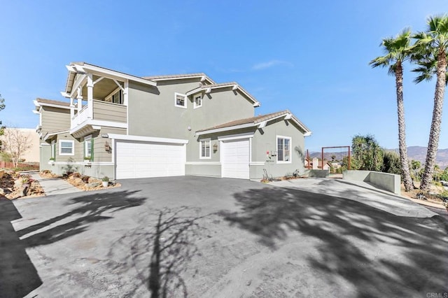 view of front of house featuring a balcony and a garage