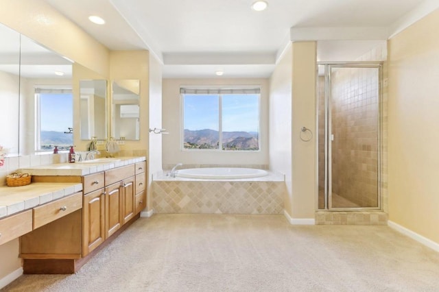 bathroom with plenty of natural light, vanity, and independent shower and bath